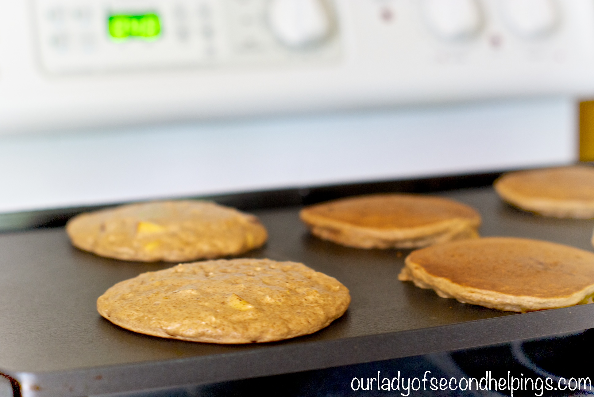 Spiced Oatmeal Buttermilk Pancakes with Nectarines Pancakes on a griddle