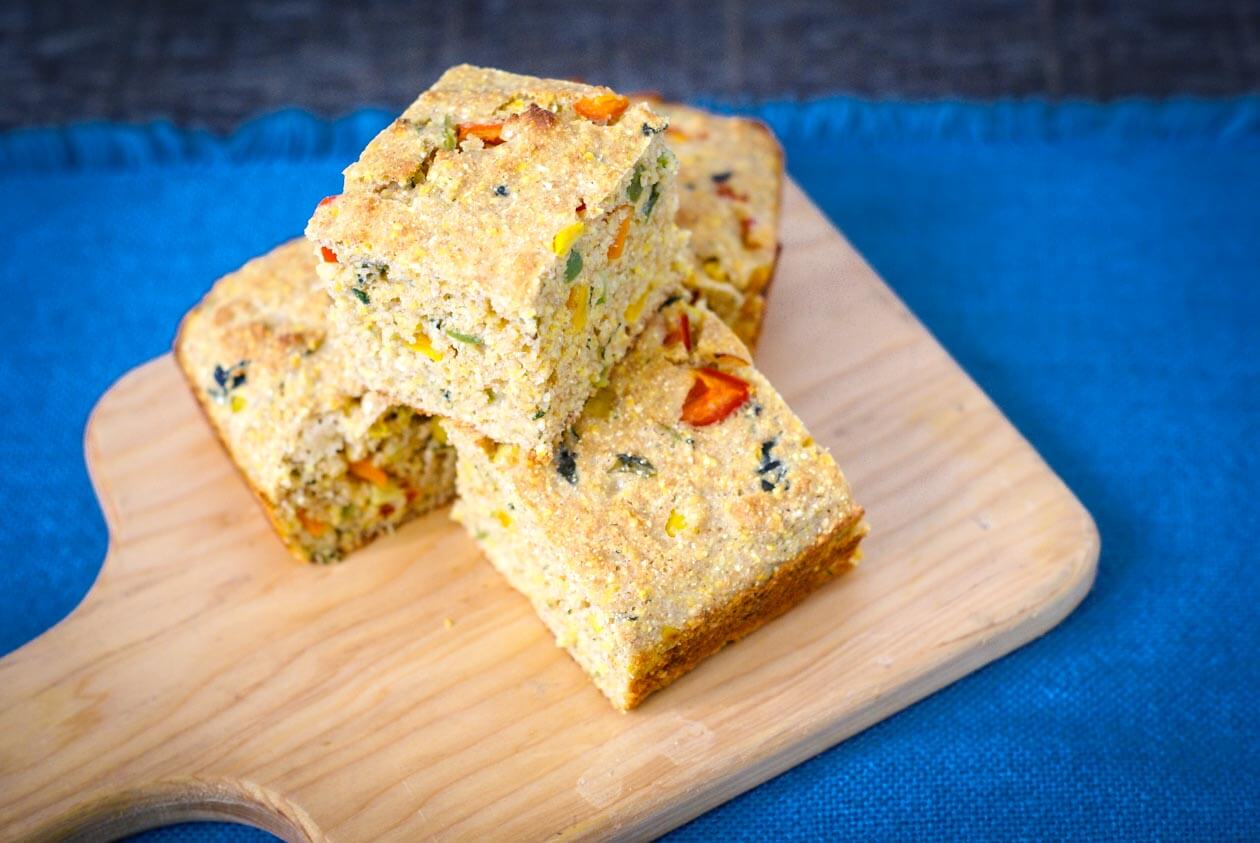 Eye catching confetti cornbread is a colorful addition to a barbecue with bursts of sweet corn and spicy jalapeños. You will love this quick & easy recipe.