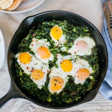 Baked eggs with crispy kale, a quick and easy recipe for breakfast or brunch. Fragrant herbs add a punch of flavor unexpected in a healthy breakfast recipe.