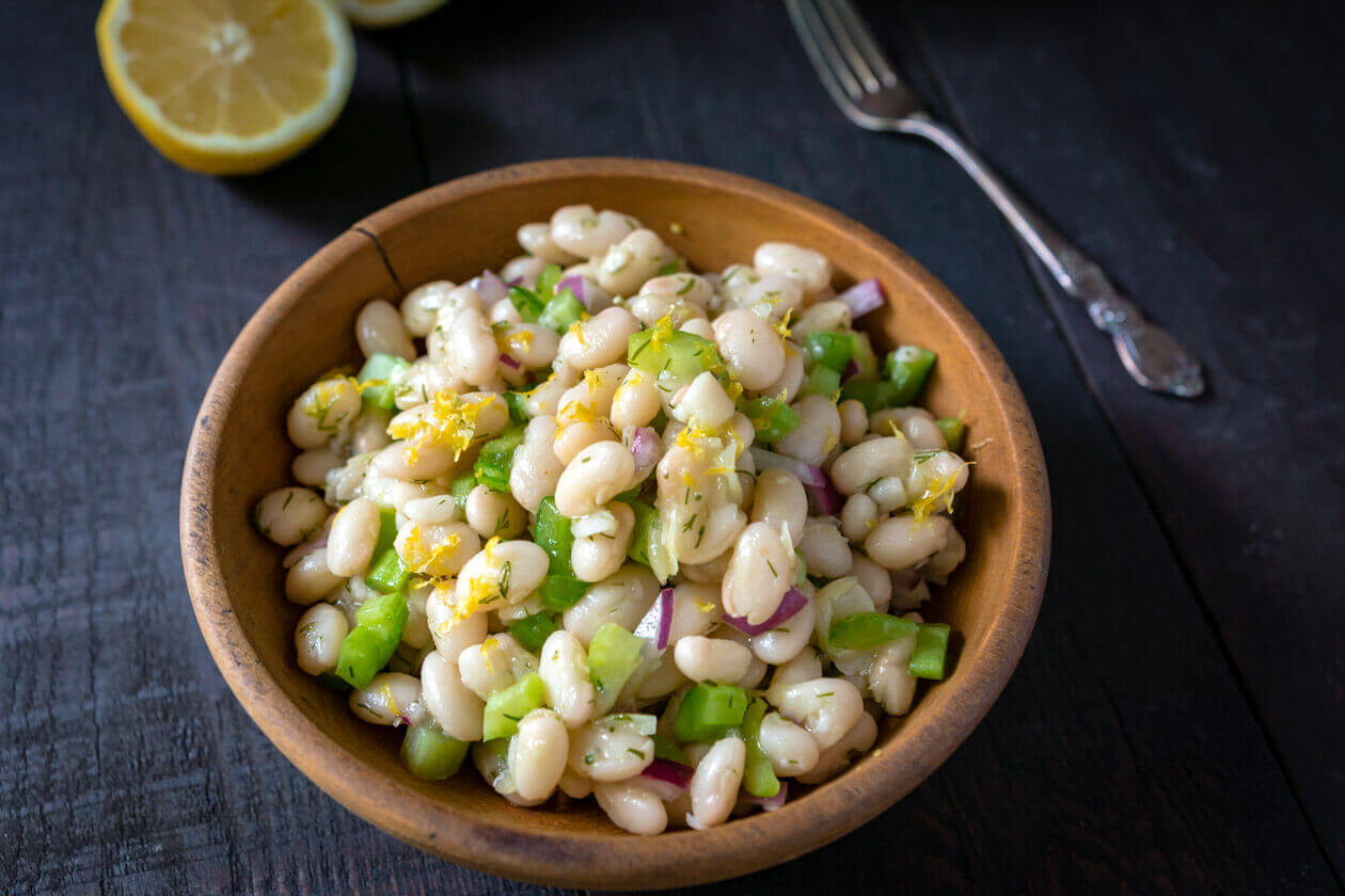 Thanks to the simple fresh flavors lemon dill navy bean salad has a lightness you might not expect from a bean salad. Quick & easy 15 minute no-cook recipe.