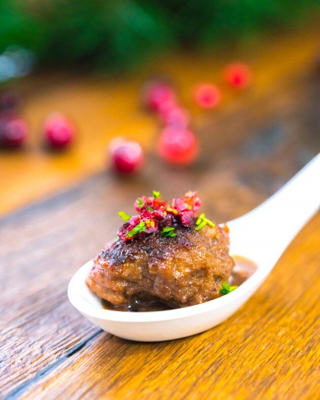 Tender cranberry glazed meatballs dotted with dried cranberries & fresh parsley, pan seared, then simmered in a sweet-tart cranberry glaze.