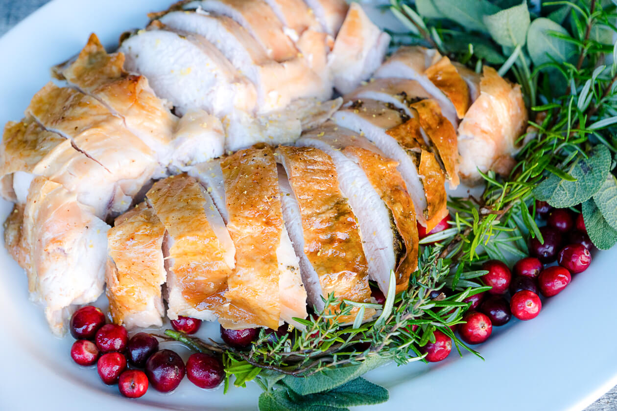 Roast turkey breast turns out tender and flavorful with this easy recipe using lemon-herb butter. Perfect for small holiday meals.