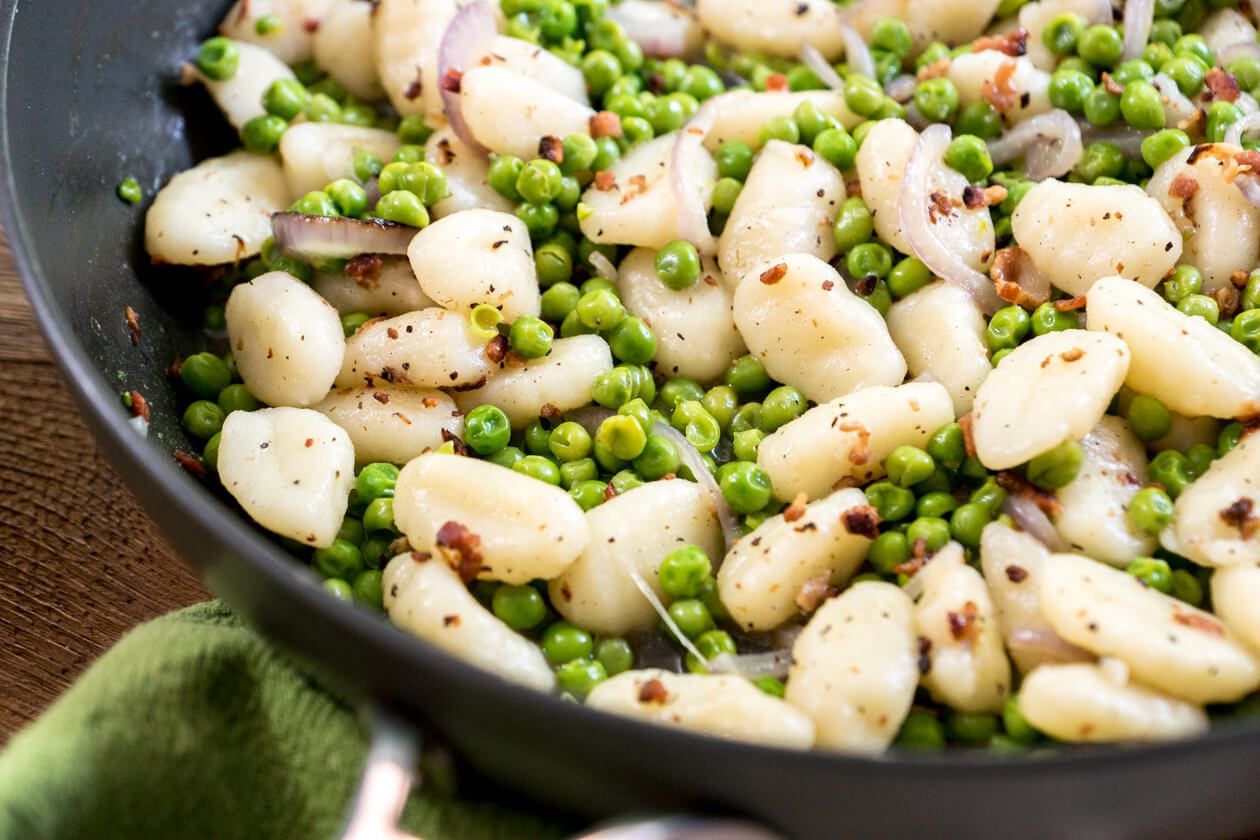 Quick and easy bacon-pea gnocchi is healthy weeknight comfort food the whole family will love. Enjoy as side dish or a meal unto itself.